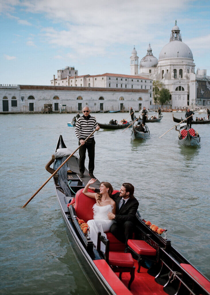 A film portrait of the Bride and Groom on the gondola at an Italy Destination Wedding at the Hotel Monaco & Grand Canal in Venice.