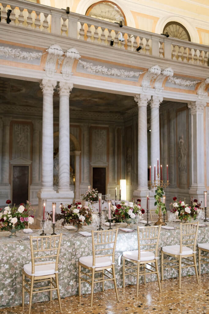 The ballroom is decked out in magenta and cream florals for the reception details at an Italy Destination Wedding in Venice.