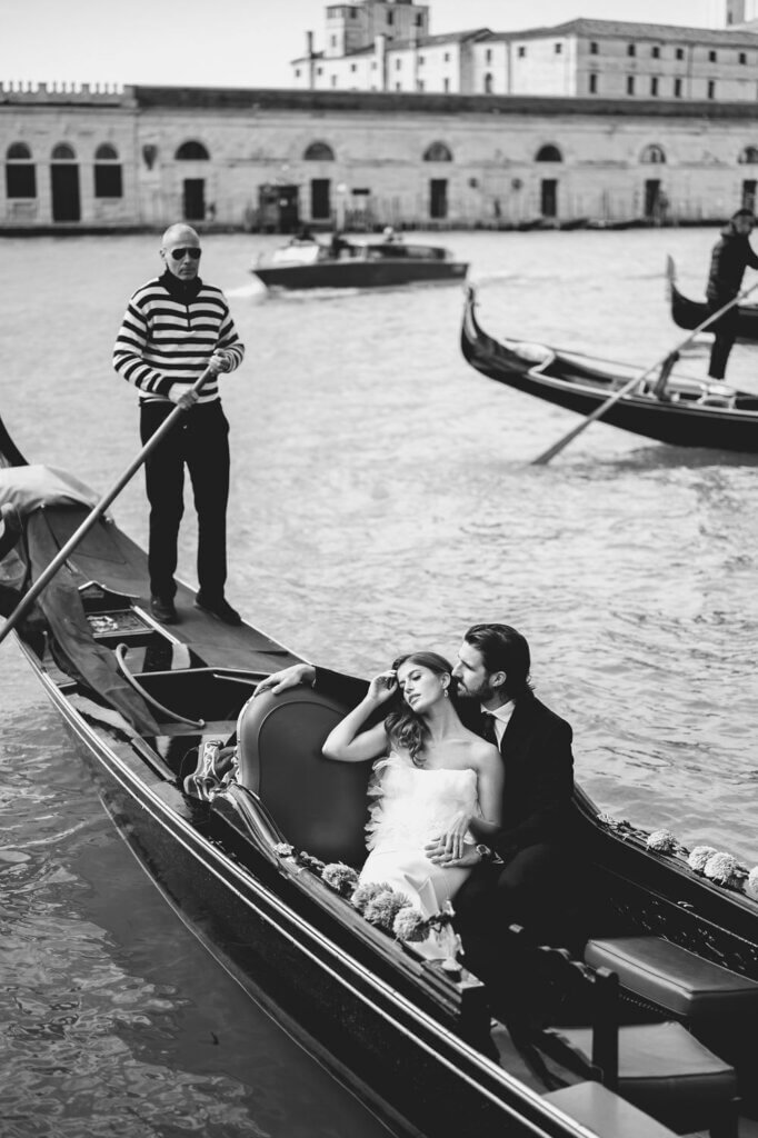 A Bride and Groom embrace on the gondola at the Hotel Monaco & Grand Canal in Venice, Italy.