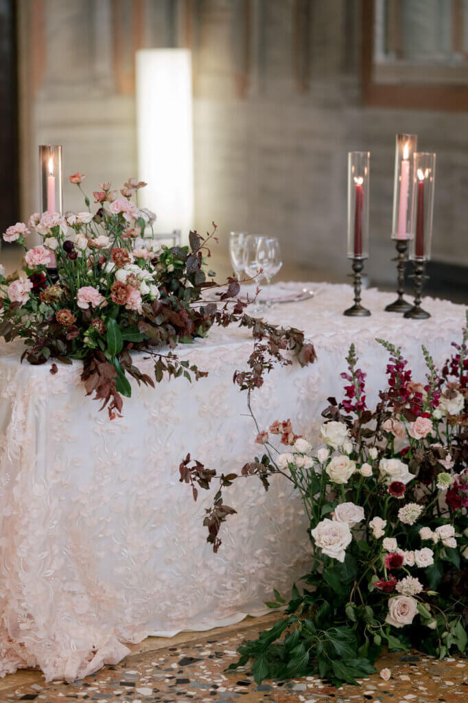 The drapes of magenta floral details on the sweetheart table at an Italy Destination Wedding in Venice.