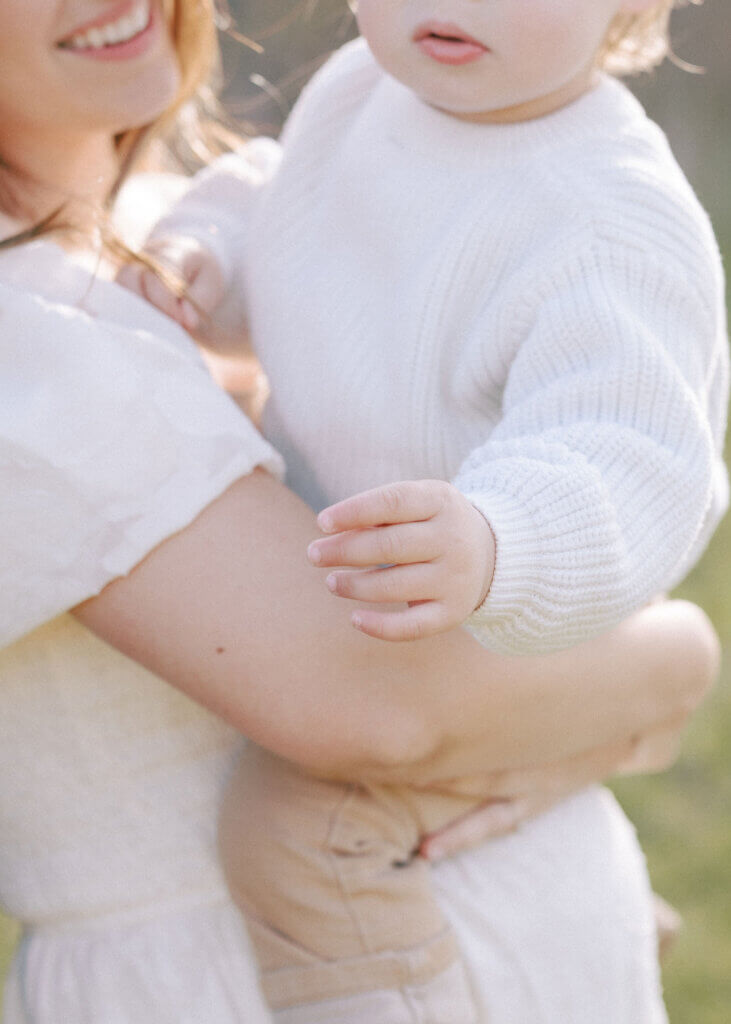 At a maternity session in Doylestown, Pennsylvania, a little boy smiles with his mom.