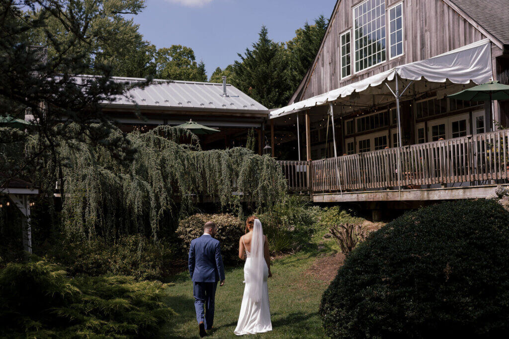 The bride and groom walk side-by-side toward their reception ballroom at Riverdale Manor in Lancaster, Pennsylvania.