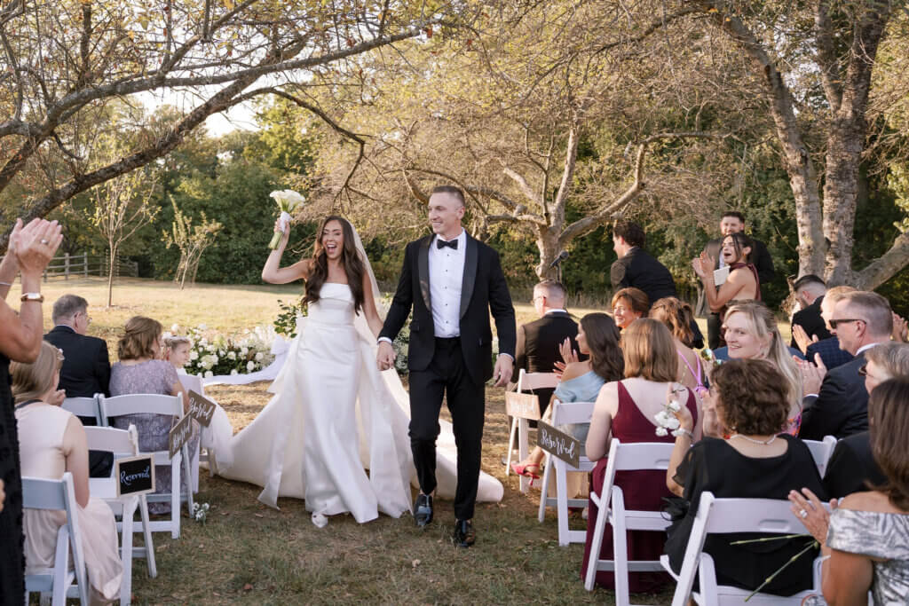 The bride and groom exit the ceremony at John James Audubon Center with Jeffrey Miller Catering.