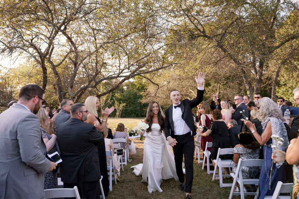 The bride and groom exit the ceremony at John James Audubon Center with Jeffrey Miller Catering.