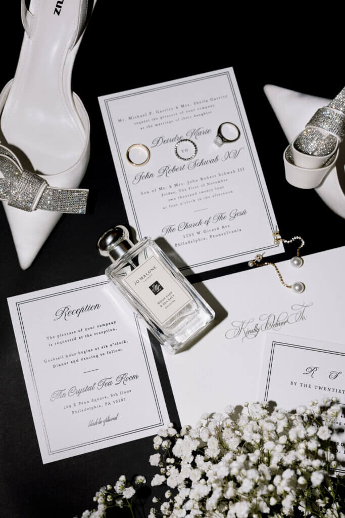 The invitation suite details photographed in a flat lay with direct flash at the Crystal Tea Room.