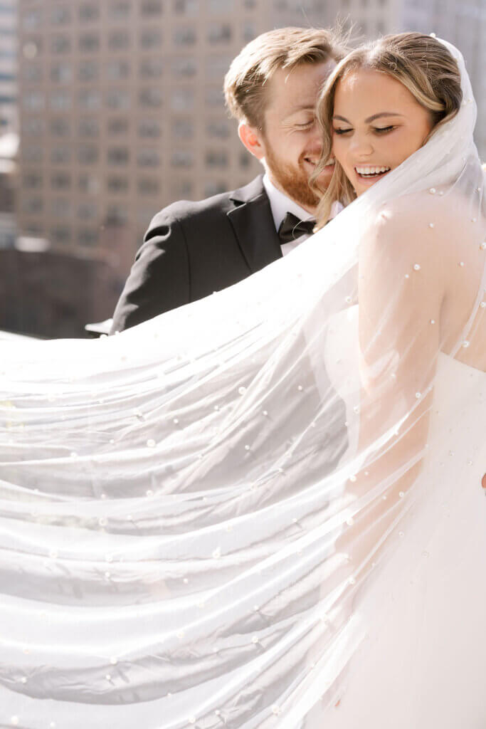 A portrait of the bride and groom laughing at their Crystal Tea Room Wedding.