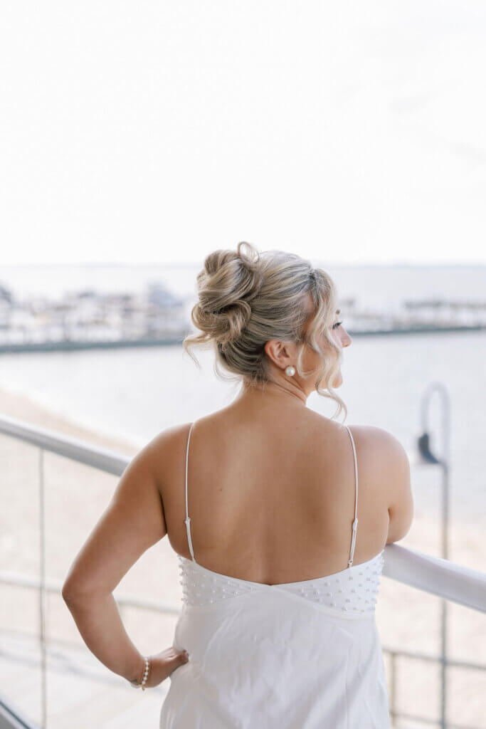 The bride in her robe while getting ready at her hotel prior to her wedding at The Rehoboth Beach Country Club. 