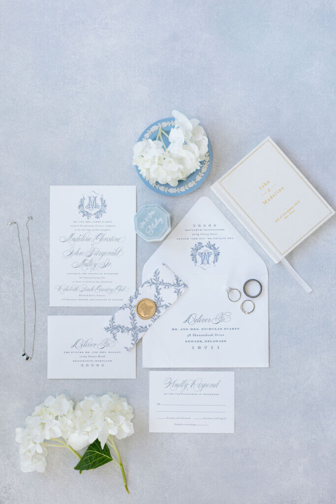 A flat lay of the floral details and stationary for the wedding by Franklin Floral Design at the Rehoboth Beach Country Club. 