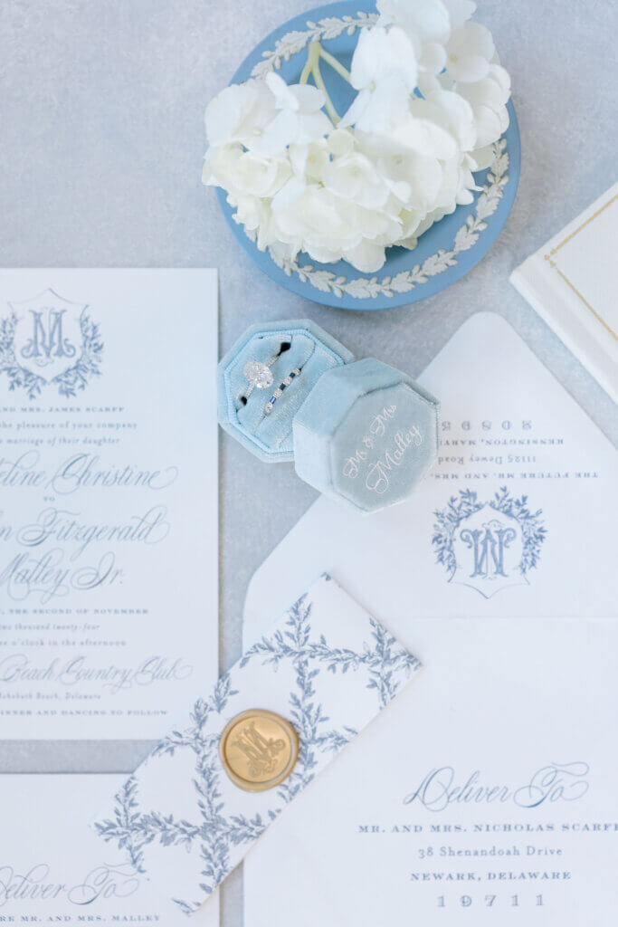 A flat lay of the floral details and stationary for the wedding by Franklin Floral Design at the Rehoboth Beach Country Club. 