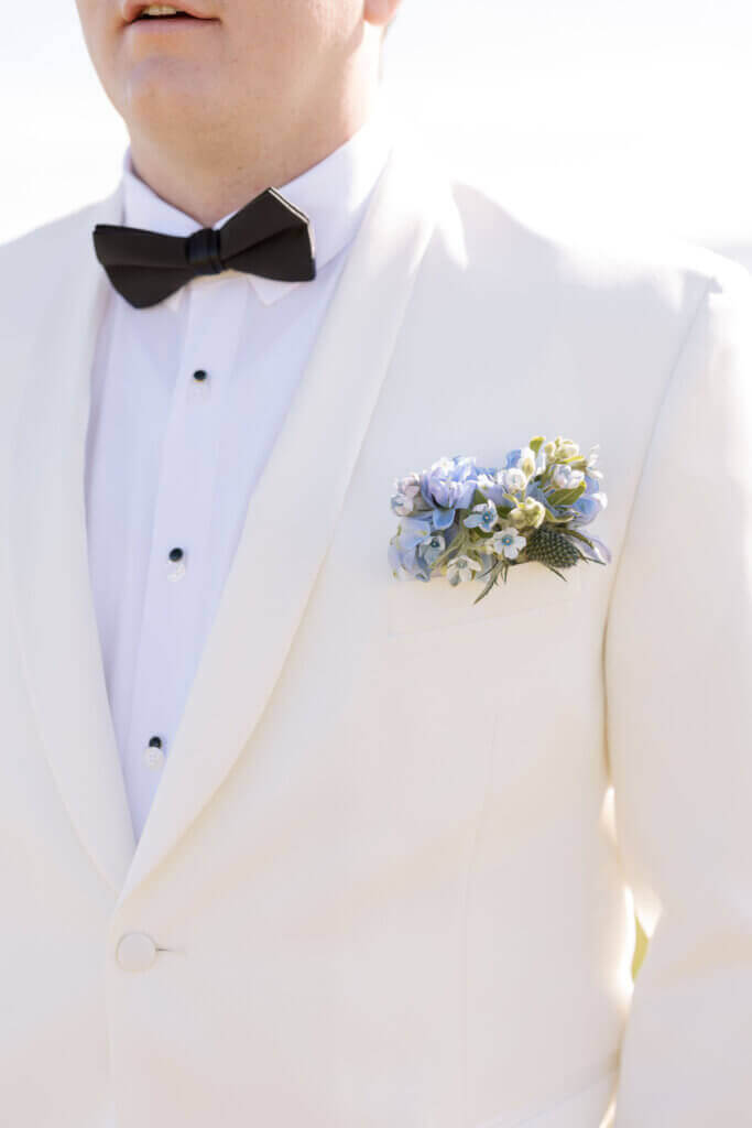 A closeup of the groom's Boutonnière by Franklin Floral Design at The Rehoboth Beach Country Club.