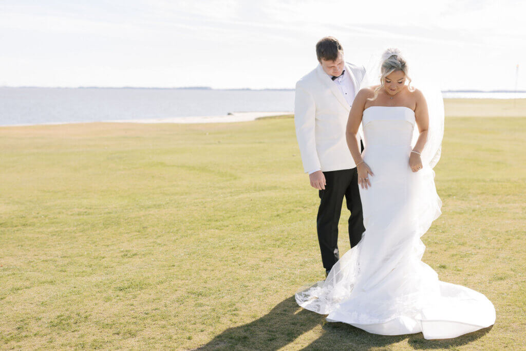 The bride and groom share vow books during their first look at The Rehoboth beach Country Club.