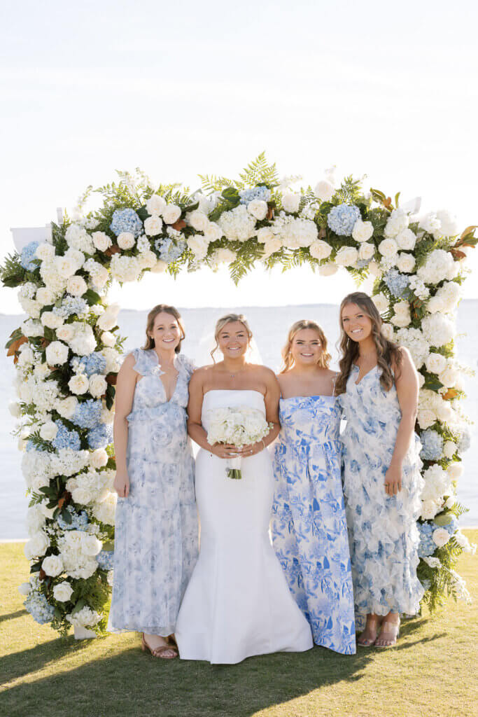 A candid portrait of the bridesmaids in printed dresses at the Rehoboth Beach Country Club. 