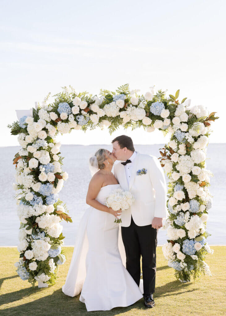 A candid portrait of the bride and groom kissing after their ceremony at Rehoboth Beach Country Club.