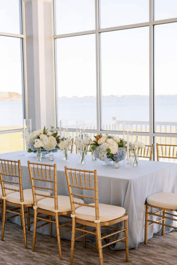 All the dainty details events planner adorns the tables with light blue and white florals and blue table cloths at the Rehoboth Beach Country Club.