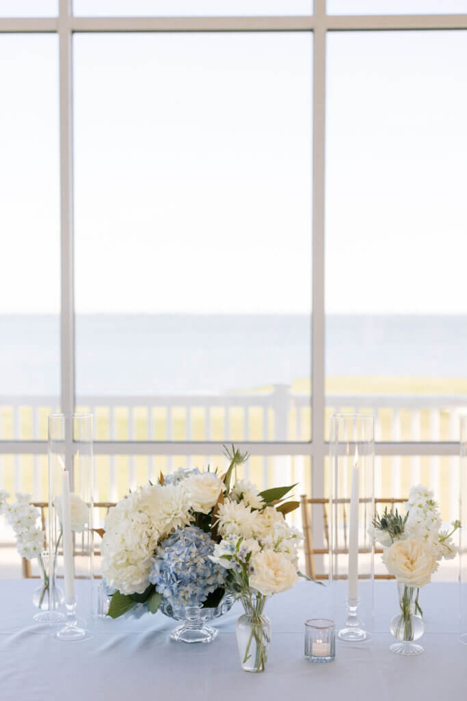 All the dainty details events planner adorns the tables with light blue and white florals and blue table cloths at the Rehoboth Beach Country Club.