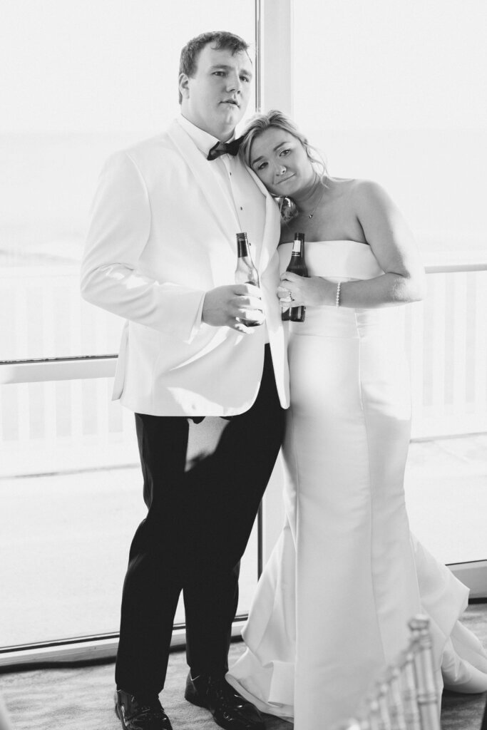 The bride and groom are emotionally listening to the father of the bride speech at Rehoboth Beach Country Club. 