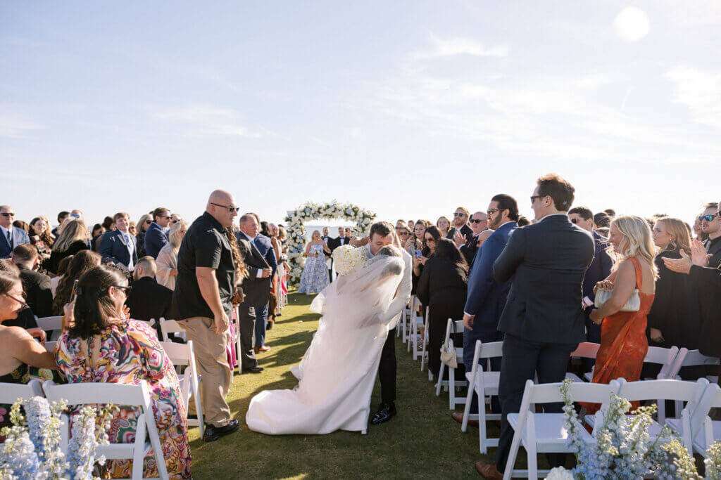 The bride and groom exit the ceremony at Rehoboth Beach Country Club. 