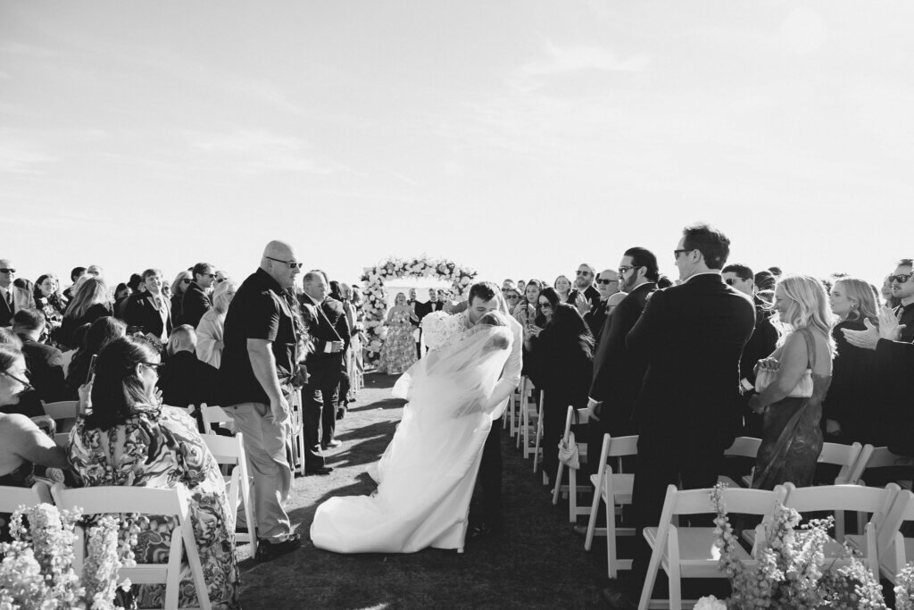 The bride and groom exit the ceremony at Rehoboth Beach Country Club. 