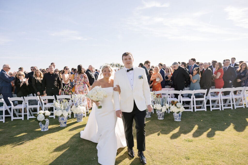 The bride and groom exit the ceremony at Rehoboth Beach Country Club. 