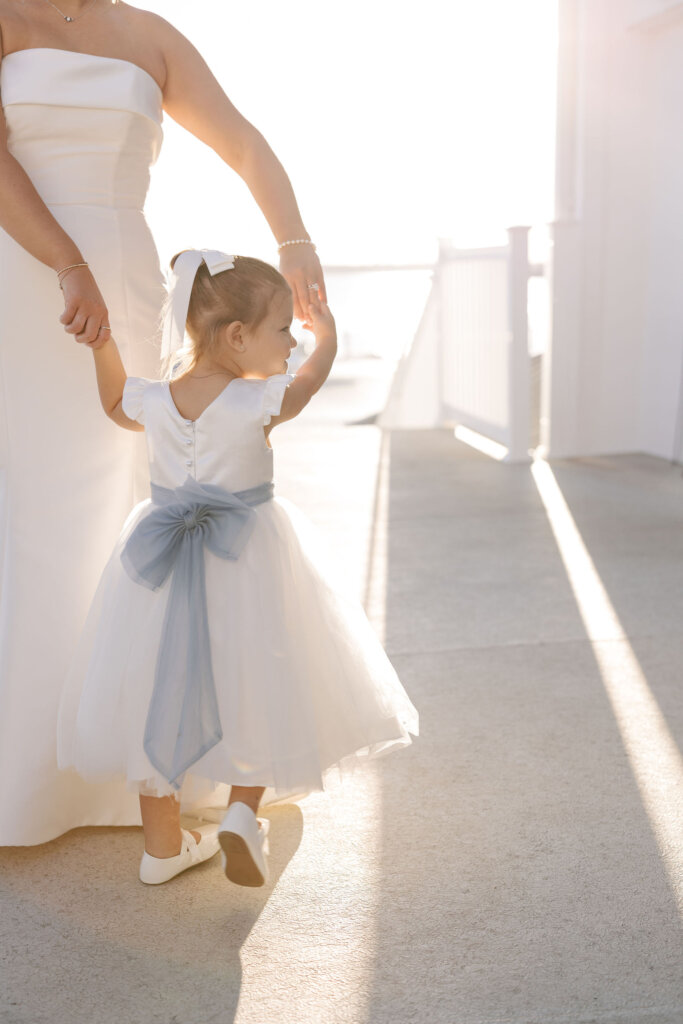 The bride dances with the flower girl at the cocktail hour at Rehoboth Beach Country Club. 