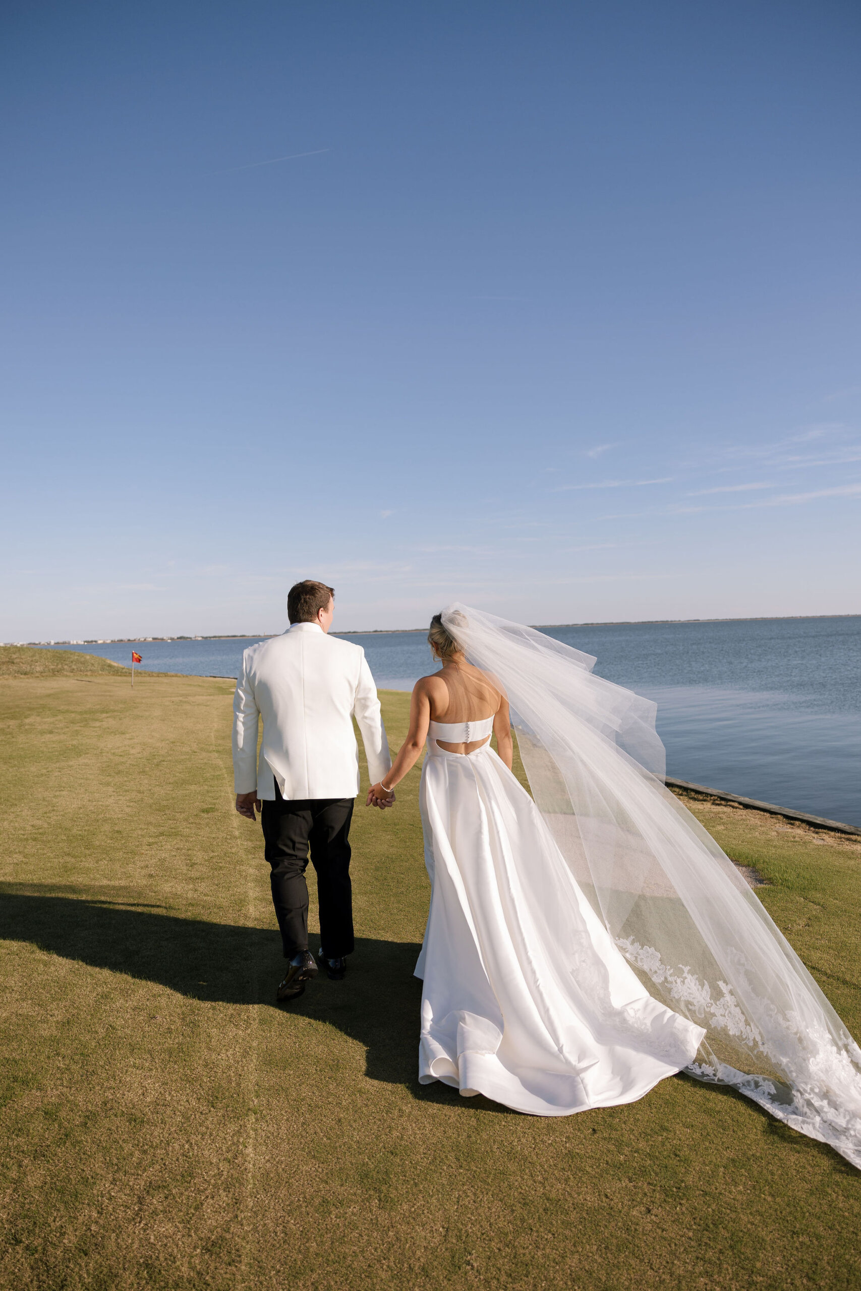 The bride and groom head to their cocktail hour after their ceremony at Rehoboth Beach Country Club.