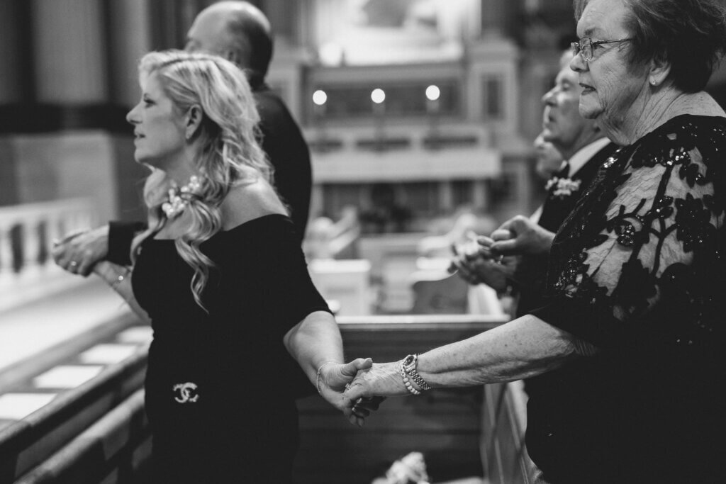 The bride and groom do a Catholic ceremony before their wedding at the Crystal Tea Room.