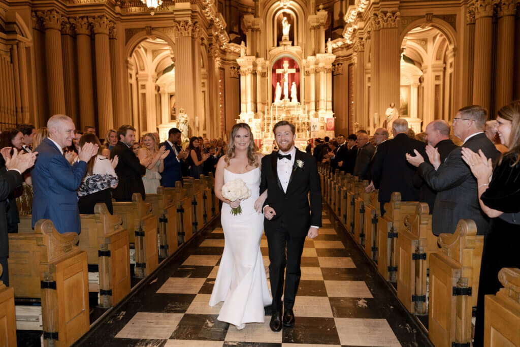 The bride and groom do a Catholic ceremony before their wedding at the Crystal Tea Room.