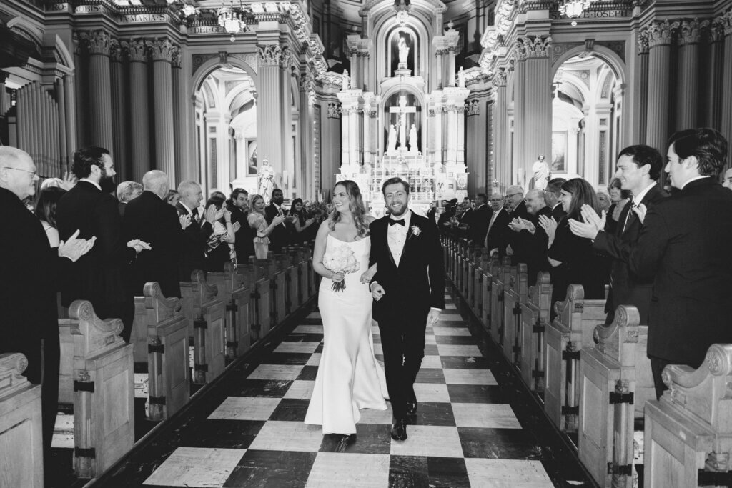 The bride and groom do a Catholic ceremony before their wedding at the Crystal Tea Room.