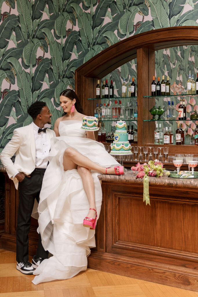 The bride on the bar with her cake at Elkins Estate.