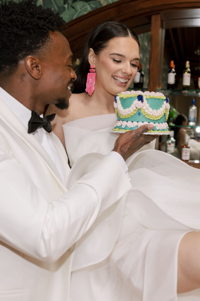 The bride on the bar with her cake at Elkins Estate.