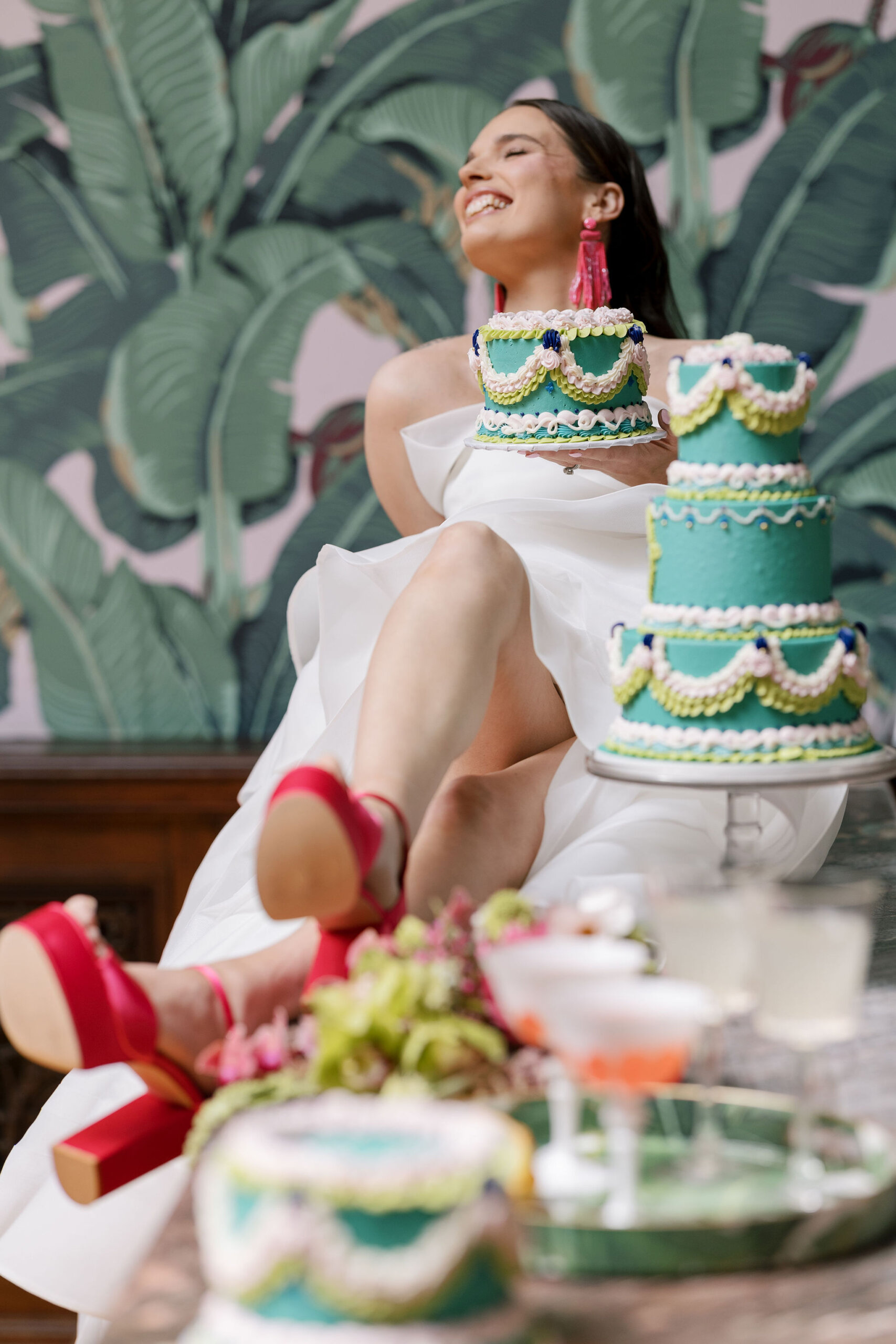 The bride sits with an amazing cake by Velvet Sky Bakery at Elkins Estate.