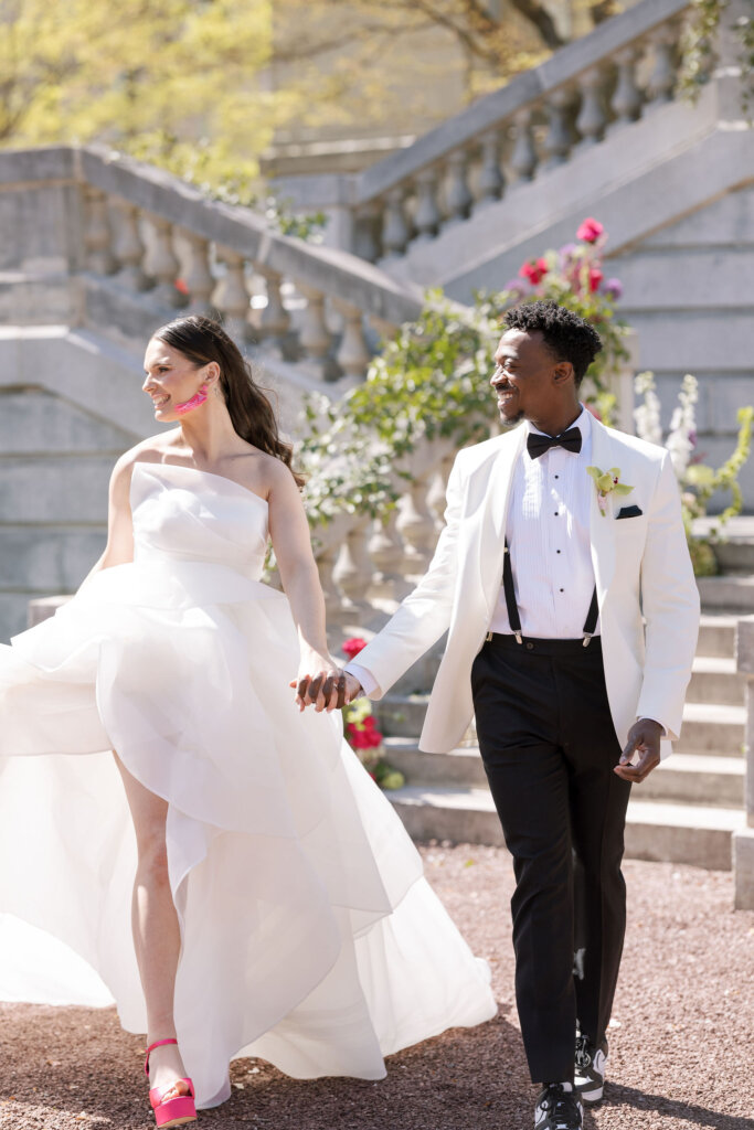 The bride and groom exit with excitement from their ceremony at Elkins Estate.
