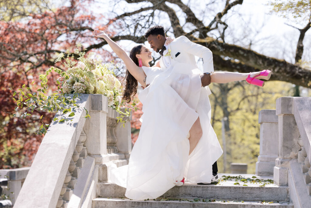 The bride and groom do a dip outside of Elkins Estate.