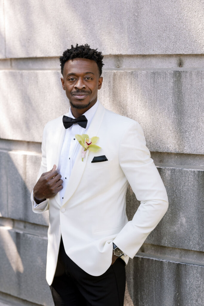 The groom stands outside Elkins Estate.