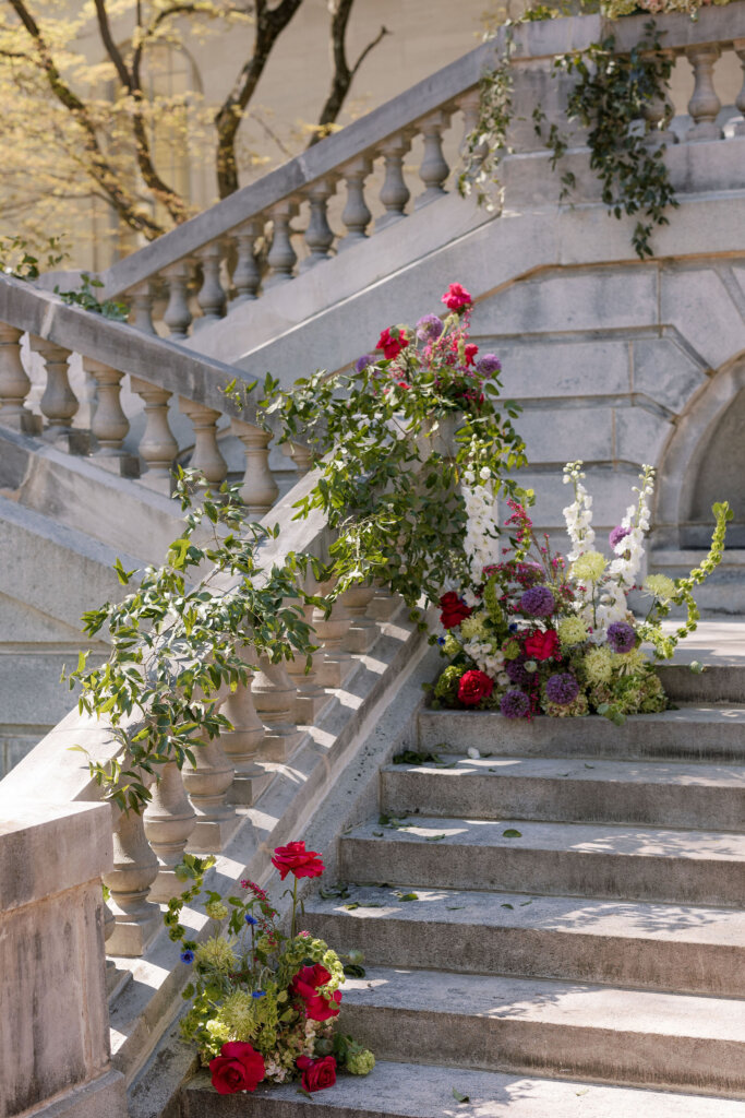 Lush florals drape the exterior of Elkins Estate for a ceremony outside by the grand staircase.
